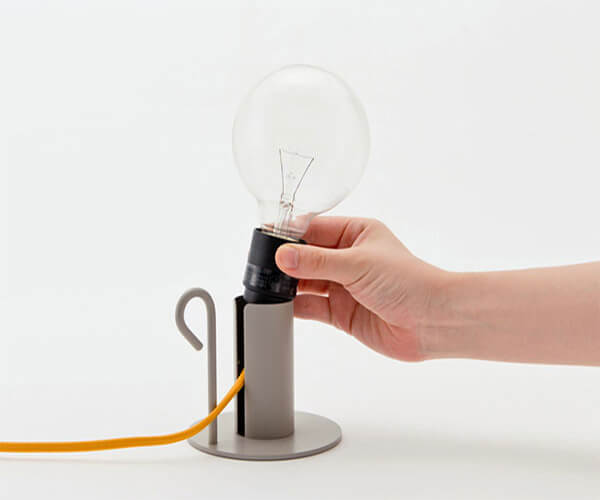 a hand places a lamp